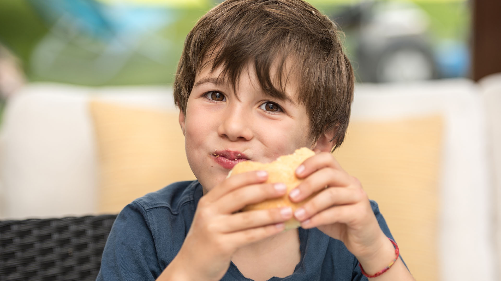 child eating a hamburger